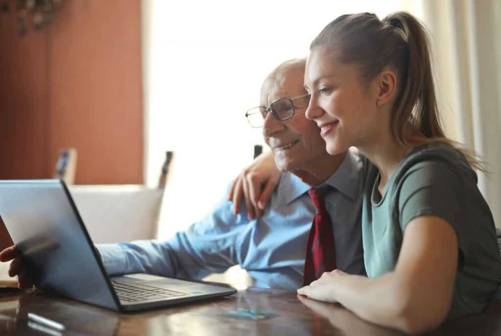 Inpatient vs Outpatient: Girl and grandpa at computer